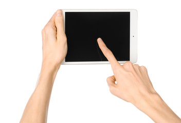Presentation and advertising touchscreen topic: human hand holding a white tablet touch computer gadget with touch blank black screen isolated on a white background in the studio, first-person view - 98538231