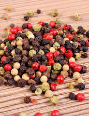 Heap of fresh colored pepper on wooden background
