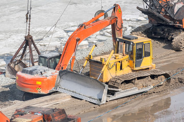 Bulldozer and crane on construction site