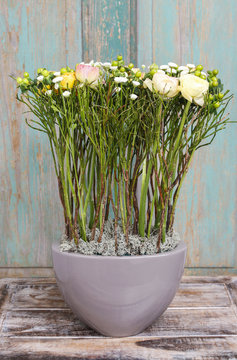 Modern floral arrangement with ranunculus flowers and green hype