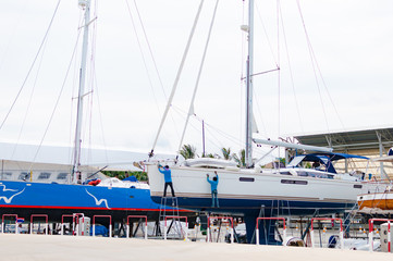 Luxury sailboat on a maintenance process in a shipyard