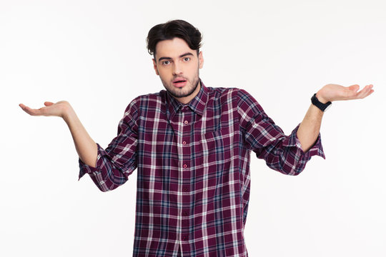 Portrait Of A Young Man Shrugging Shoulders