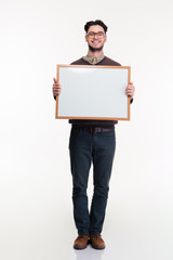 Smiling man holding blank board