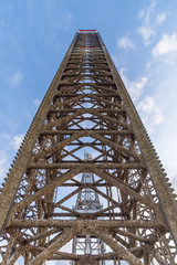 Jack up oil rig leg with blue sky when alomost fully up