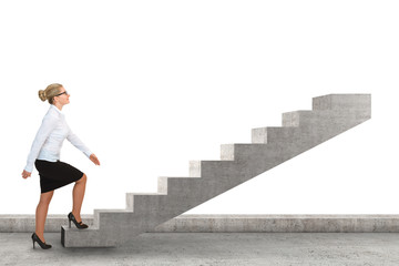 Business woman walking up a staircase. Isolated on white
