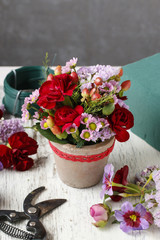 Florist workplace: Floral arrangement with red carnations and hy