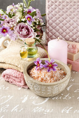 Bottle of essential oil, bowl with sea salt and scented candle