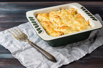 Potato casserole with meat on the wooden table