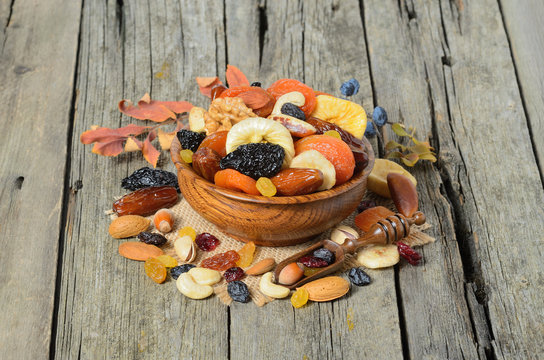 Mix of dried fruits and nuts in a wooden bowl - symbols of judaic holiday Tu Bishvat. 