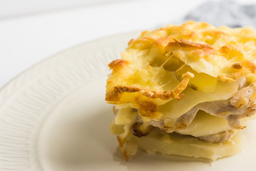 Potato casserole with meat on the wooden table