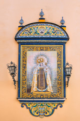 Fototapeta na wymiar The tiled icon on wall of oldest city Church of Santa Ana, loca