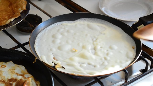 Preparation of pancakes in kitchen