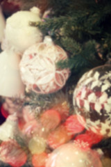 Blurred christmas decorations hanging on christmas tree with lig