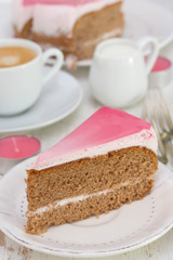 cake on white plate and cup of coffee on white wooden background