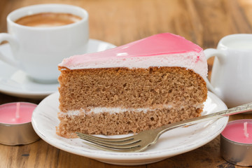 cake on white plate and cup of coffee on brown background