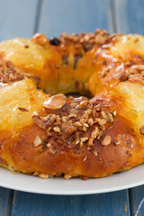 Christmas fruit cake on white plate on blue wooden background
