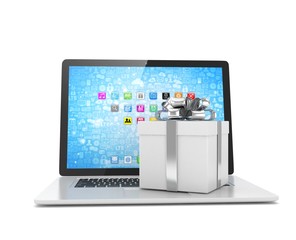 Gift box with ribbon bow on laptop keyboard