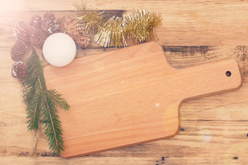 brown cutting board with Christmas decoration on brown wooden background