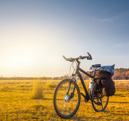 Naklejka na ściany i meble bicycle among a prairie at the sunset