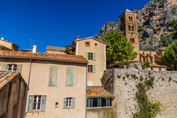 Fototapeta na wymiar Church Tower And House-Moustiers St Marie,France