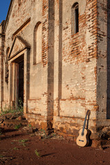 Classical acoustic guitar in ruins of abandoned church at Palmit