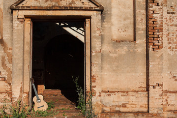 Classical acoustic guitar in ruins of abandoned church at Palmit