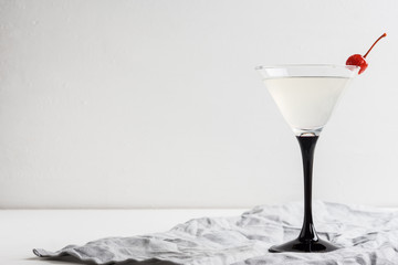 Cocktail in martini glass on the wooden background