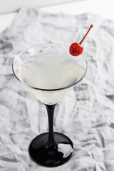 Cocktail in martini glass on the wooden background