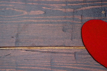Wool half of heart on the wooden background