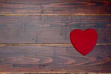 Wool heart on the wooden background