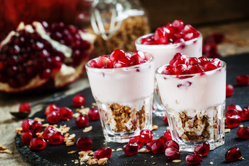Breakfast with baked muesli, yoghurt and pomegranate, portioned