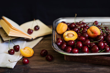 Strawberry Apricot Cherry on a metall tray, rustic style, dark background