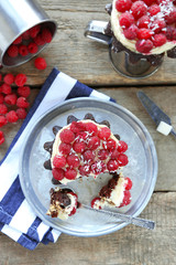 Sweet cake with raspberries on wooden table background
