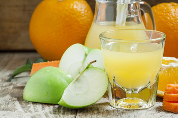 Fresh juice from the orange, green apple and carrot, selective f
