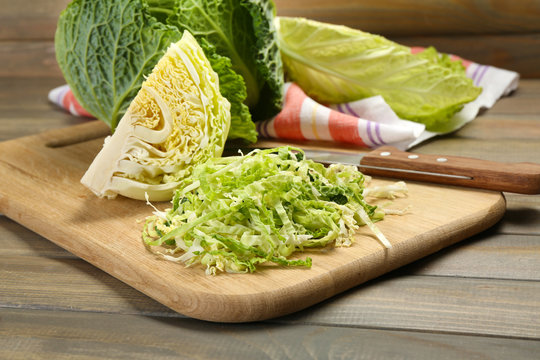 Cut savoy cabbage on wooden cutting board