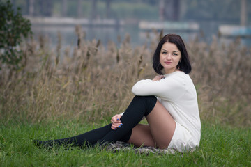 young woman sitting on the grass
