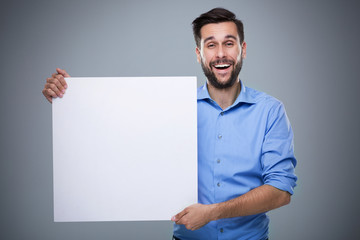 Man holding blank poster
