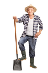 Mature farmer posing with a shovel