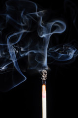 Ignited match and blown off match isolated on black