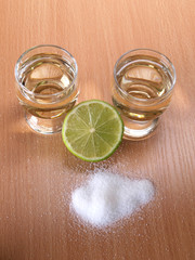 Glass cup with tequila on table
