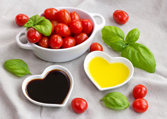 Snack tomatoes, basil, oil and vinegar to make a healthy salad