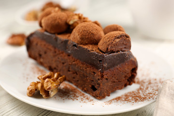 Piece of chocolate cake with walnut on the table, close-up