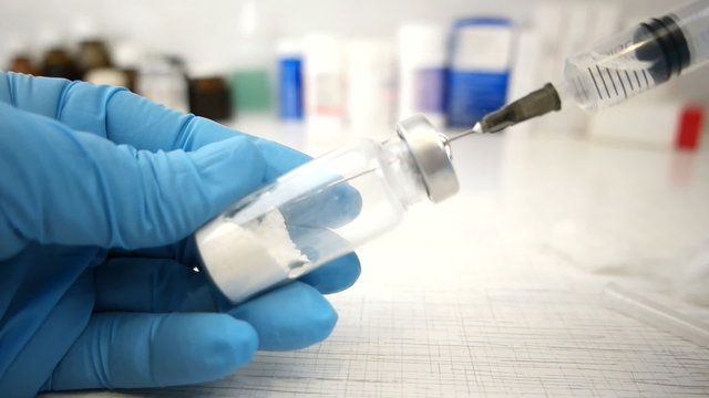 Female doctorFemale doctor carefully preparing an injection