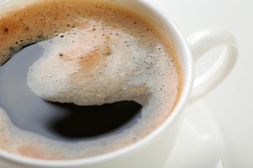 A cup of tasty coffee, isolated on white, close-up
