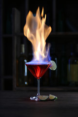 Burning cocktail and lime on table in a bar