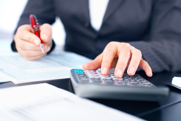 Hands of accountant business woman with calculator.
