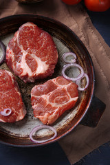 Marbled beef steak on pan and spices on color wooden background