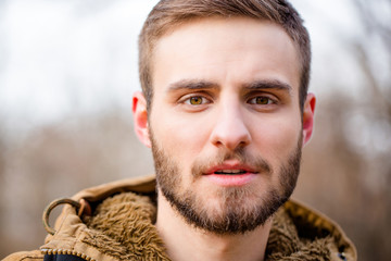 Man looking at camera outdoors
