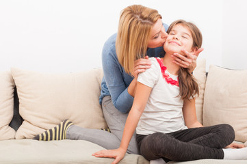 Beautiful mother and daughter on the couch or sofa