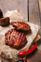 Roasted beef fillet and vegetables on cutting board, on wooden background